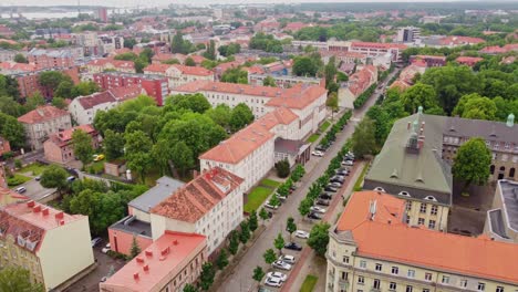 Aerial-View-of-City-Neighborhood-with-Red-Rooftops-and-Green-Trees