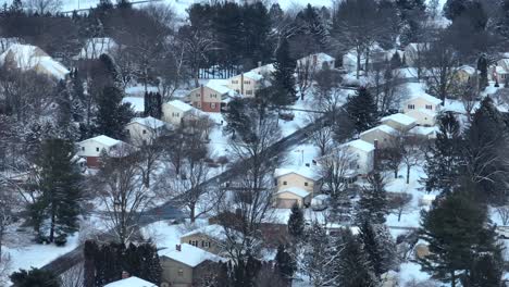 Aerial-view-showing-snowy-homes-in-suburb-district-of-American-town