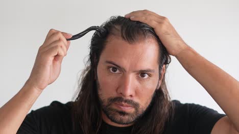 man-wearing-roller-hair-on-his-head-to-prevent-baldness,-Hair-treatments