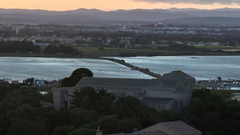 French-coastal-town-of-Maguelone-and-cathedral-at-sundown,-Aerial-dolly-right-shot