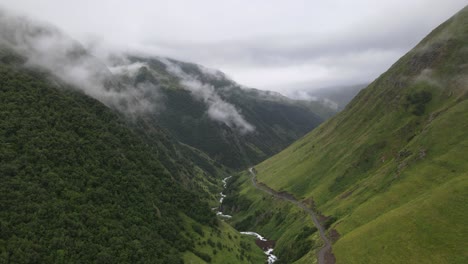 Aerial-shot-of-caucasian-mountains-fog-valley-river