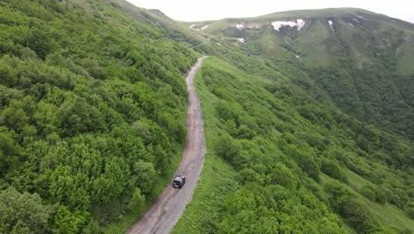 A-winding-path-through-rolling-hills-and-a-lush-green-valley,-showcasing-the-natural-beauty-and-tranquility-of-the-countryside