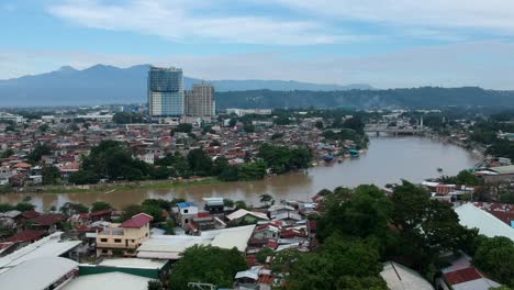 Unique-Drone-captures-stunning-aerial-cinematic-footage-of-Davao-City's-skyline,-showcasing-its-vibrant-cityscape-and-breathtaking-landscapes-in-a-spectacular,-dynamic-perspective