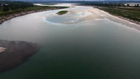 Scenic-high-aerial-shot-of-beautiful-Canyon-Lake-with-calm-water-and-Texas-landscape-during-dusk