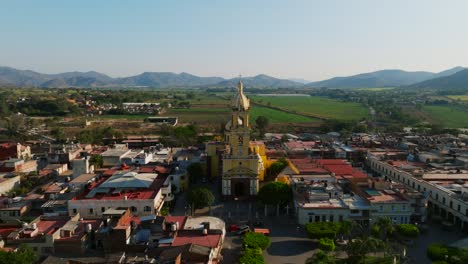 Dolly-in-drone-shot-of-Our-Lady-of-the-Sanctuary-church-facade-in-Tamazula,-Mexico