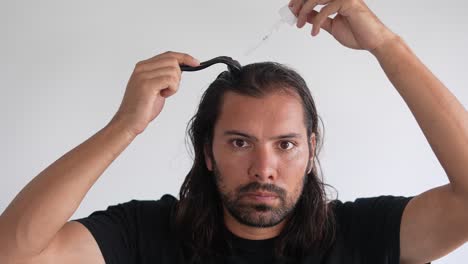 man-using-roller-hair-on-his-scalp-to-prevent-baldness,-Thinning-hair