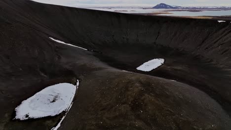 Spectacular-aerial-footage-of-the-Hverfjall-volcano-crater,-filmed-by-a-drone-in-a-circular-flight,-showcasing-the-majestic-beauty-of-this-Icelandic-natural-wonder