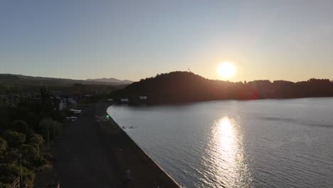 Sunrise-behind-the-mountains-and-shores-of-Villarrica-Lake-near-Pucon,-Chile