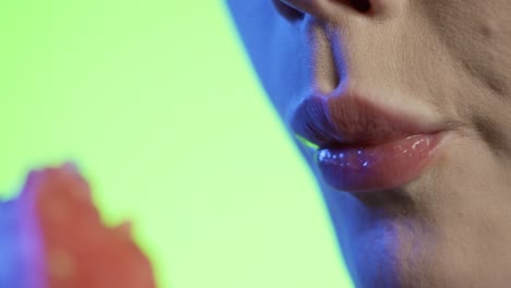 woman-eating-watermelon-in-close-up,-girly-nail-polish-and-red-lipstick-lips-on-green-background