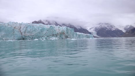 Glacier-and-Arctic-Sea-on-Coast-of-Greenland,-View-From-Moving-Boat,-Slow-Motion