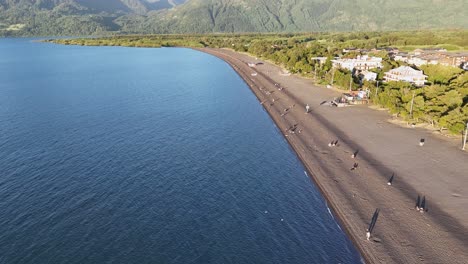 High-panoramic-flight-over-the-shores-of-lake-villarrica-in-Chile