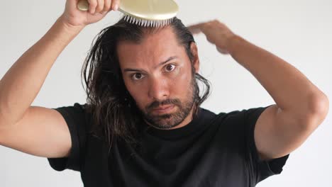 man-using-brush-on-his-head-with-baldness,-Paddle-brush,-latino-man,-hair-growth