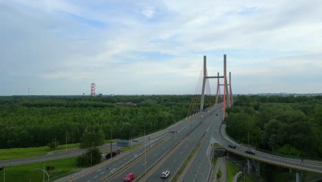 Rising-drone-wide-shot-of-traffic-on-Siekierkowski-bridge-over-Vistula-river-in-Poland