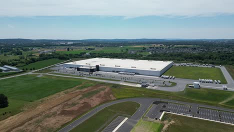 Aerial-drone-view-of-business-park-that-includes-warehouses,-factories,-and-gas-station