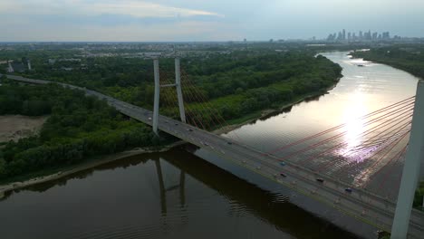 Siekierkowski-Bridge-And-Vistula-River-At-Sunset-In-Warsaw,-Poland---Aerial-Drone-Shot
