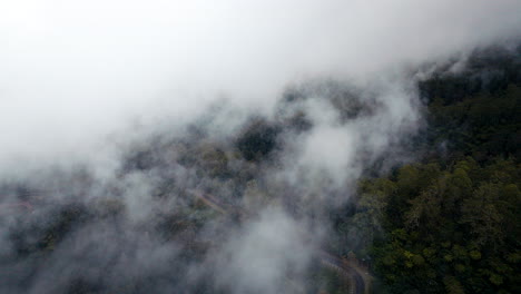 Volando-A-Través-De-Las-Nubes-Sobre-La-Ladera-Del-Monte-Agung-Durante-El-Amanecer-En-Bali,-Indonesia