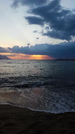 Vertical,-Sunrise-Behind-Clouds-Above-Mediterranean-Sea-and-Sandy-Beach