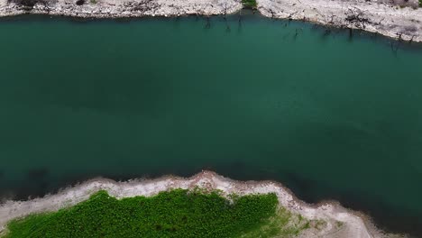 Aerial-scenic-bird's-eye-view-of-calm-water-on-Canyon-Lake-shoreline-in-Texas