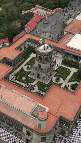 Vertical-aerial-shot-of-Chapultepec-Castle-on-a-cloudy-afternoon-in-Mexico-City