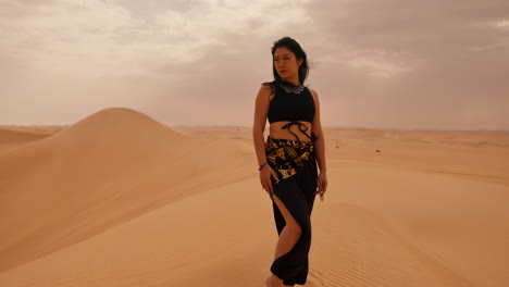 Woman-Walking-in-the-Desert-with-Black-Traditional-Attire