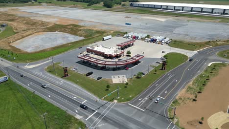 Aerial-drone-view-of-business-park-including-as-station,-warehouses,-and-factories