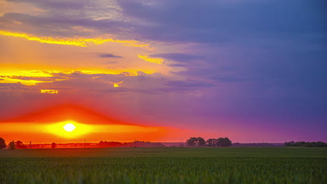 Timelapse-shot-of-sun-rising-over-the-horizon-and-vanishing-into-dark-rain-clouds-along-rural-countryside-during-morning-time