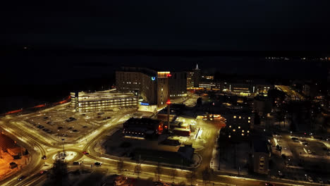 Aerial-view-descending-in-front-the-hospital-of-Vaasa,-winter-evening-in-Finland