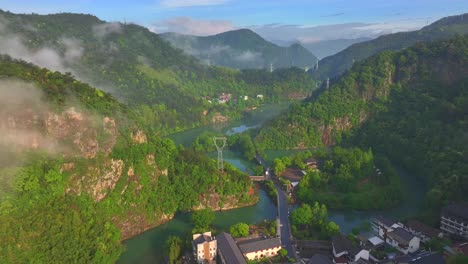 Aerial-photo-of-Tonglu-Mountain-Village-in-Hangzhou,-Zhejiang,-China,-surrounded-by-clouds-and-mist-in-the-early-morning，Beautiful-Countryside-in-China