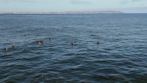 Surfers-Enjoying-the-Pristine-Blue-Waters-of-La-Jolla-in-San-Diego,-California,-USA---Wide-Shot