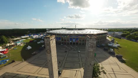 UEFA-EURO2024-Olympic-Stadium-Berlin-FPV-Drone-passing-olympic-rings-and-towers-over-stadium-roof-onto-pitch