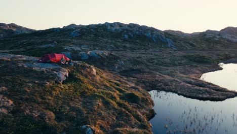 A-Man-Camping-Amidst-the-Rocky-Mountains-of-Skurven,-Eidsvoll,-Akershus,-Norway---Drone-Flying-Forward