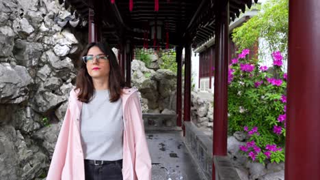 European-woman-enjoying-a-walk-in-Yuyuan-Garden-in-Shanghai,-China