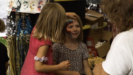 Children-enjoying-face-painting-at-the-50th-Anniversary-Dogwood-Festival-in-Arkansas,-USA,-slow-motion