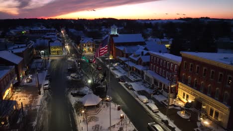 Traffic-on-main-street-in-snowy-cityscape-during-golden-sunset-in-USA