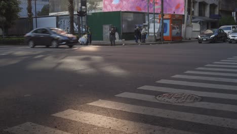 Intersection-with-tall-building-with-urban-art-mural,-Mexico-City-North-America