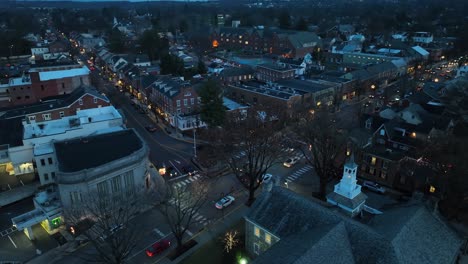 Traffic-on-main-street-of-small-town-at-dusk