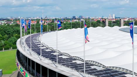 Drone-Travelling-Shot-UEFA-EURO2024-Olympic-Stadium-Country-Flags-Green-Trees