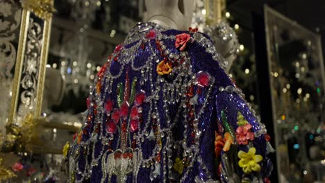 Dolce-And-Gabbana-artistic-fashion-exhibition-showcasing-a-collection-of-unique-and-elaborate-clothing-designs-in-a-creatively-lit-gallery