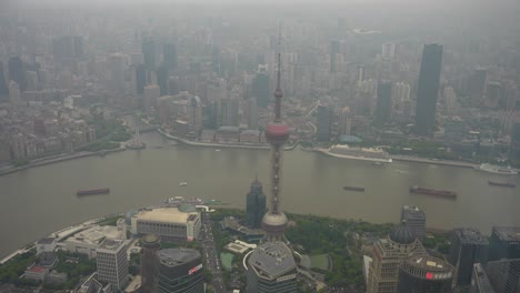 Aerial-view-of-Oriental-Pearl-Tower-and-Huangpu-River-in-Shanghai-with-smog