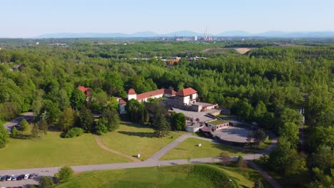 Drone-moves-left-to-right-and-enters-in-orbit-view,-house-near-river-with-lots-of-trees-around-and-garden-area