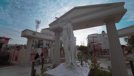 Panning-shot-of-a-statue-of-the-Greek-mythology-muse-named-Clio-in-a-park-called-Paseo-de-las-Musas-in-the-province-of-Chiclayo,-Lambayeque,-Peru