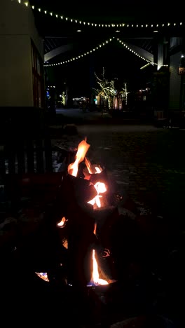 Vertical-Video,-Outdoor-Gas-Fire-Pit-in-Cold-Winter-Christmas-Night,-Lake-Tahoe-Ski-Resort,-California-USA
