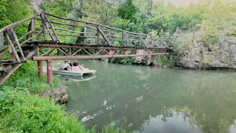 Pedalo-boat-paases-under-wooden-footbridge-Zlatna-Panega-river-trip