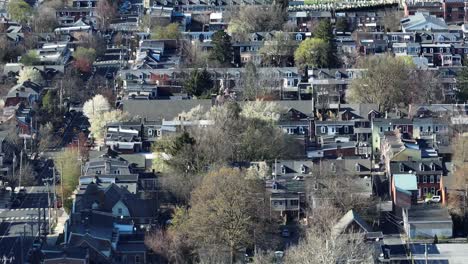 Aerial-lateral-shot-of-american-housing-area-with-spring-trees-at-sunny-day