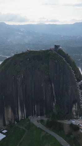 Vertical-mode-views-of-El-Peñon-de-Guatape,-captivating-drone-perspectives