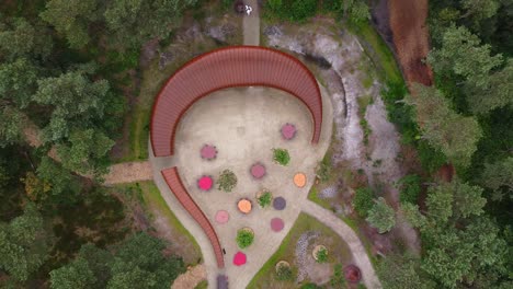 Top-down-aerial-view-of-archtectural-tourism-building-inside-the-sahara-forest-in-Lommel,-Belgium