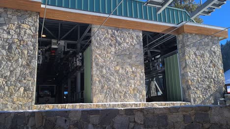 Lake-Tahoe-Ski-Resort-Gondola-Lift-Station-and-Moving-Cabin-on-Sunny-Winter-Day,-Close-Up