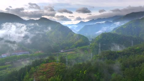 Aerial-photo-of-Tonglu-Mountain-Village-in-Hangzhou,-Zhejiang,-China,-surrounded-by-clouds-and-mist-in-the-early-morning，Beautiful-Countryside-in-China