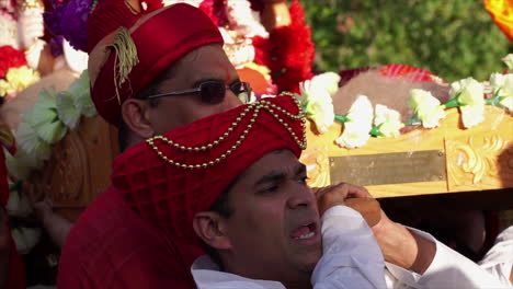 Hindu-men-in-turbans-carry-Ganesh-murti-on-palanquin-litter