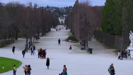 Visitors-walking-through-the-gardens-of-Schönbrunn-Palace-in-Vienna,-Austria